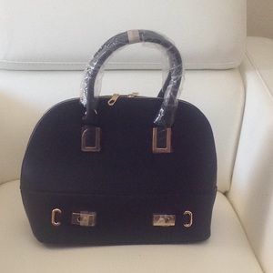 A classic black bowler purse with shoulder strap.